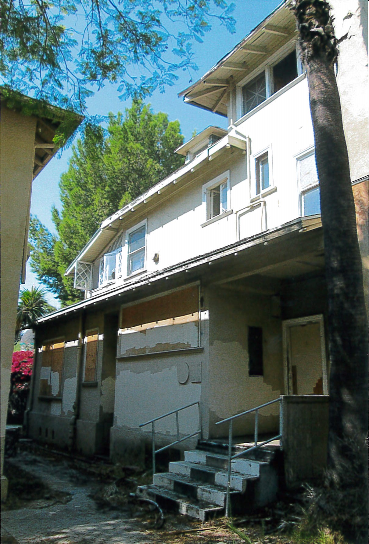 Exterior view, boarded up buildings.